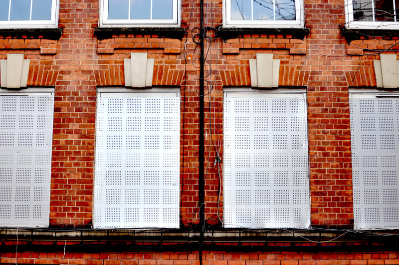 Metal grates cover multiple windows of many homes on Sutton Estate, Chelsea. March 2022.
"No Rights Reserved" (CCO) 